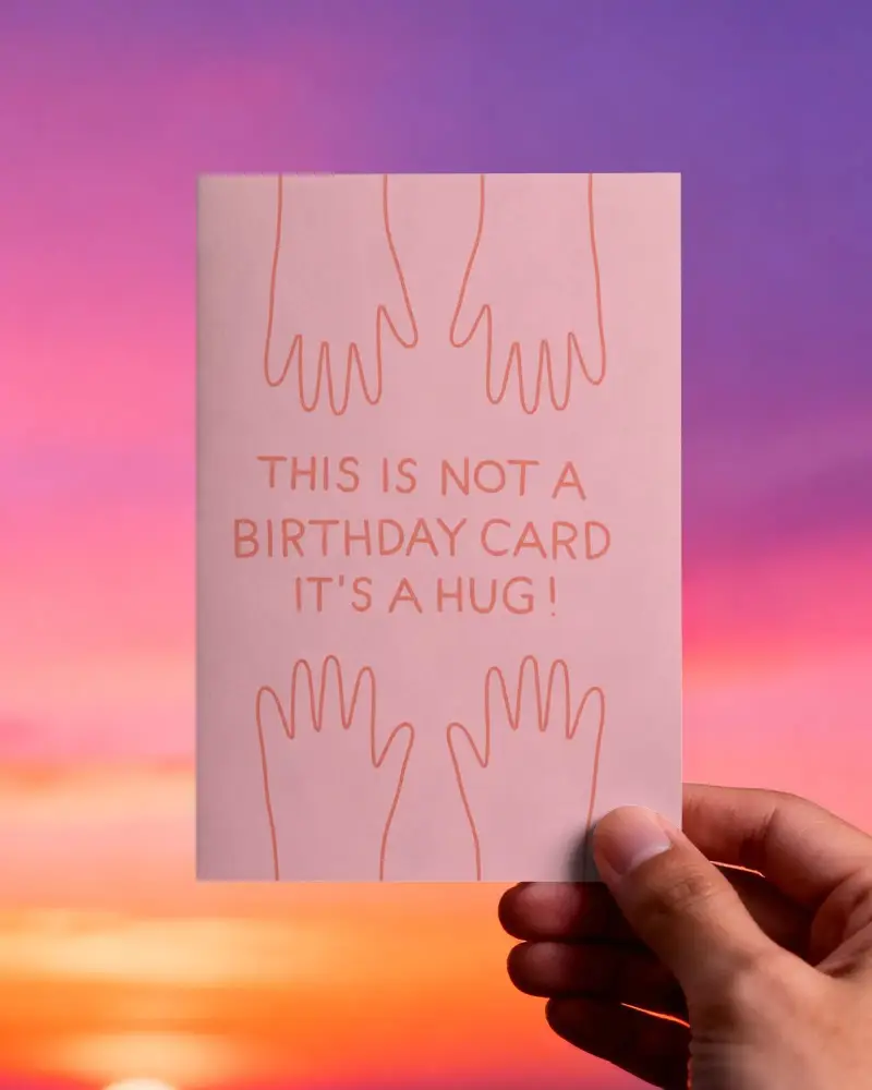 Hand Holding Minimalist Greeting Card Mockup With Sunset Sky Backdrop For Customized Message