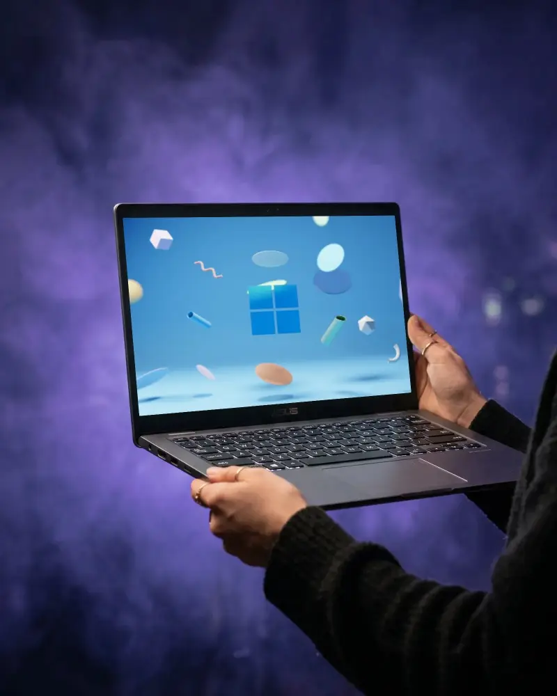 Person Holding Laptop With Blank Screen Technology Device Showcasing Digital Content