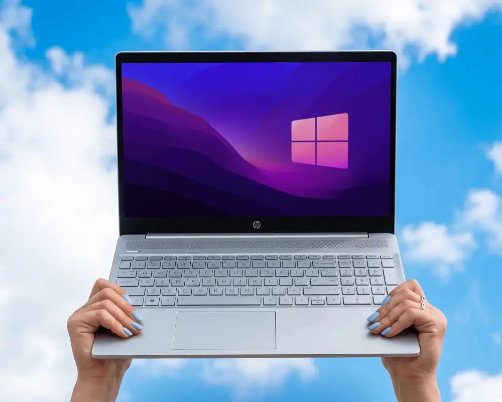 Hands Holding Modern Hp Laptop With Blank Screen Against Clear Blue Sky Background For Mockup