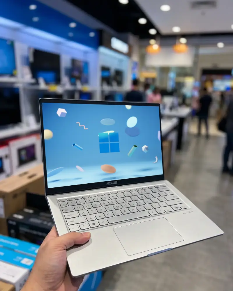 Hand Held Portable Asus Laptop Mockup With Blank Screen On Electronics Retail Store Display