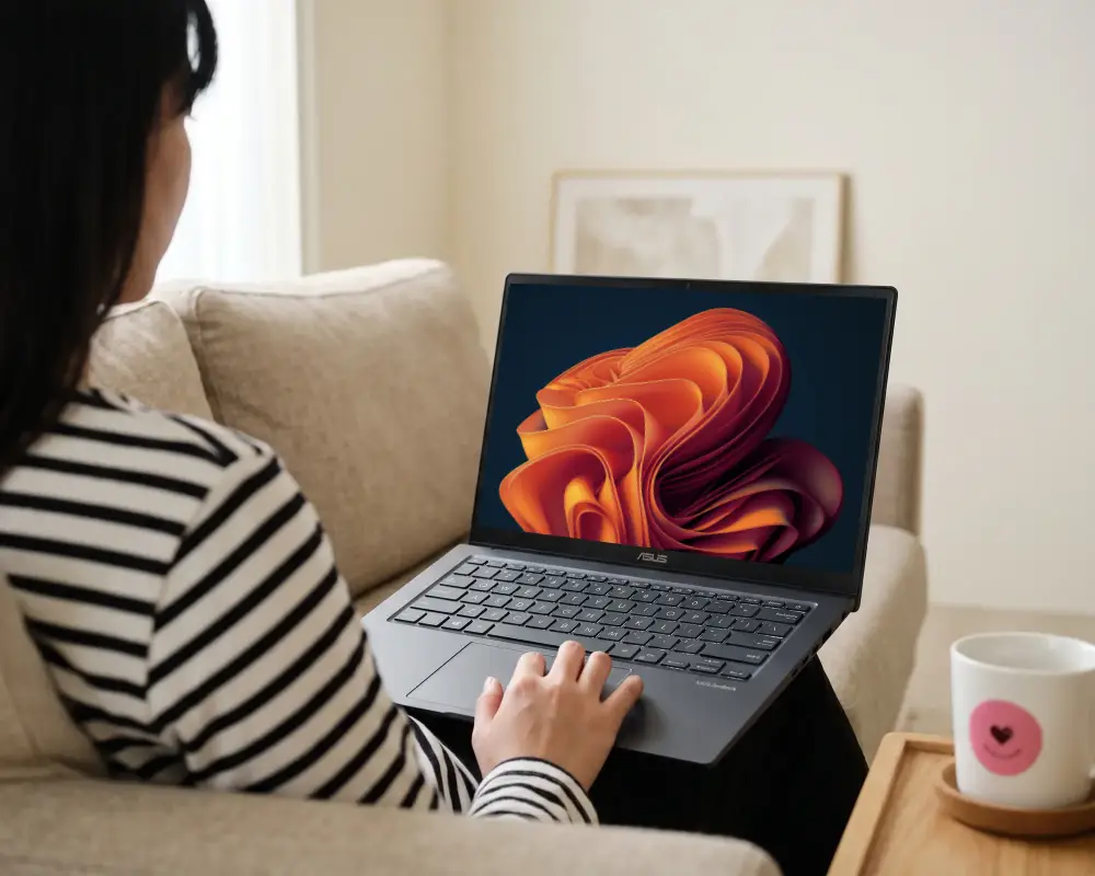 Woman Using Asus Laptop Mockup On Comfortable Sofa In Modern Home Environment For Remote Work