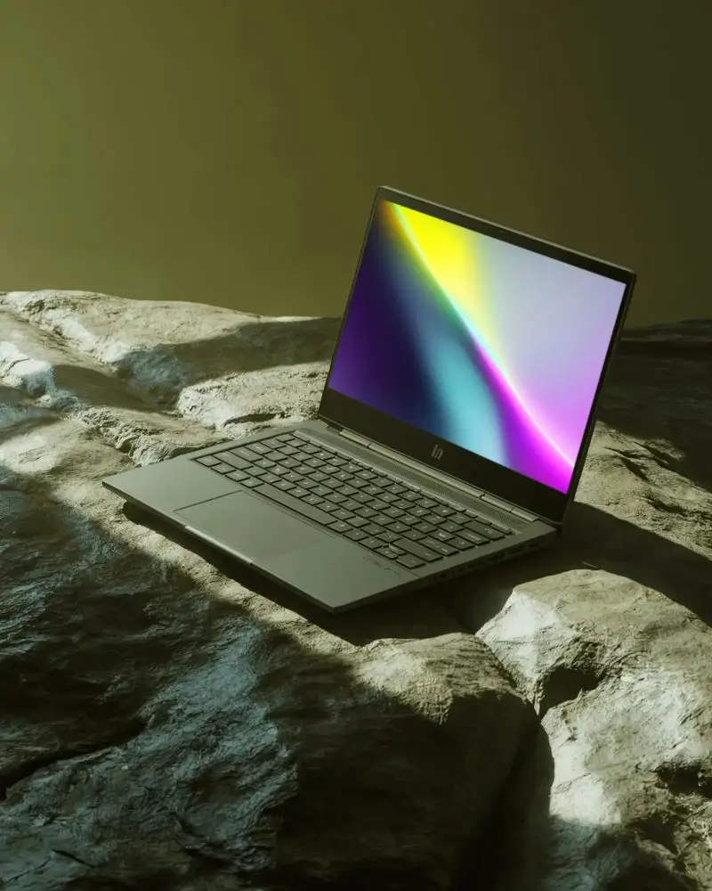 Modern Hp Laptop Mockup With Empty Screen On Textured Rock Surface For Tech Presentation