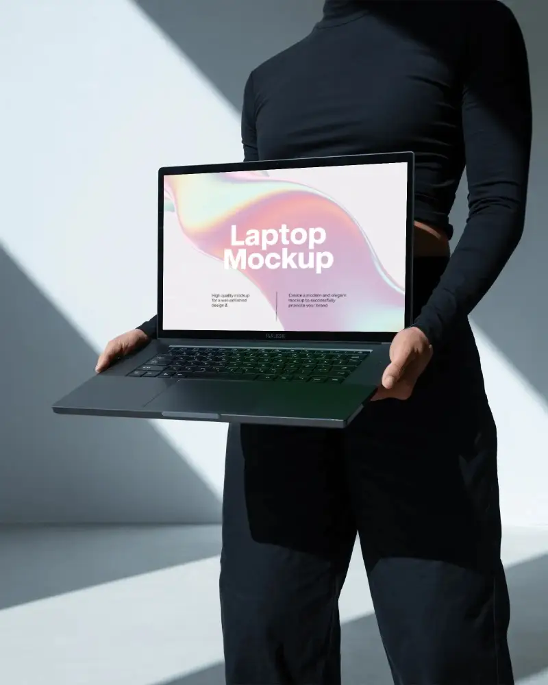 Razer Laptop Mockup Held By Person In Black Outfit With Strong Light Shadows In Minimal Studio Space