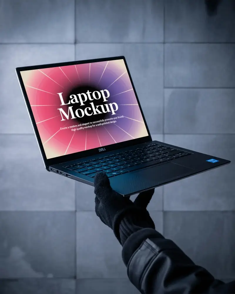 Dell Laptop Mockup Held By Gloved Hand Against Dark Stone Tile Wall In Industrial Modern Setting