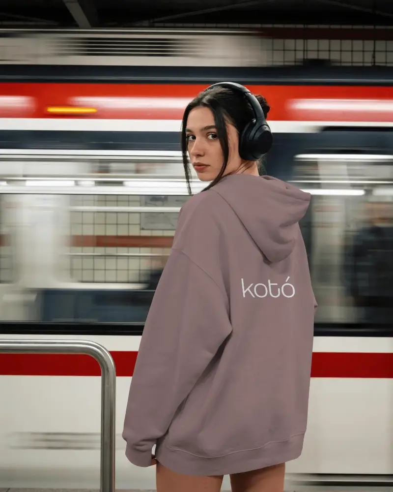 Trendy Oversized Hoodie Logo Mockup Model In Subway Station With Headphones Accessory