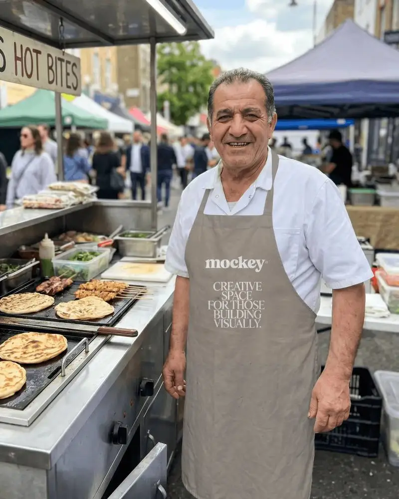 Street Food Vendor Wearing Clean Apron Preparing Grilled Platters For Passing Customers