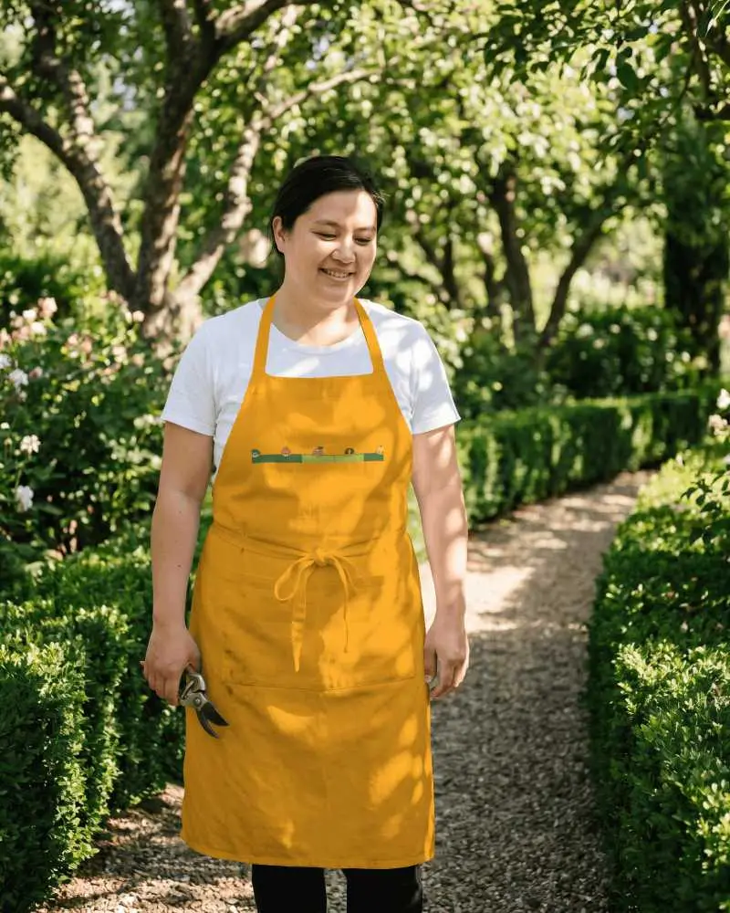 Garden Apron Mockup Female Gardener Standing On Sunlit Pathway With Greenery Background