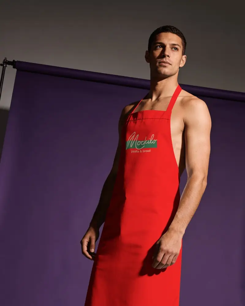 Fashion Studio Barber Apron Mockup Male Model Posing Against Purple Backdrop With Dramatic Light
