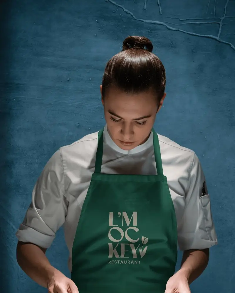 Professional Culinary Chef In Apron Mockup With Folded Sleeves Showcasing Modern Kitchenwear