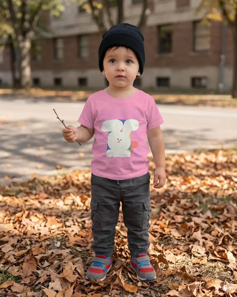 Realistic Baby Tee Mockup With Kid Standing Outdoor Autumn Themed Background For Branding Use