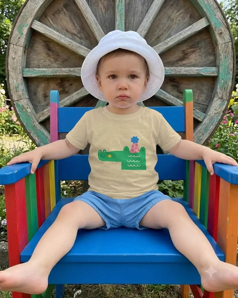 Adorable Baby Tee Mockup On Kid In Outdoor Setting With Rainbow Colored Chair Background