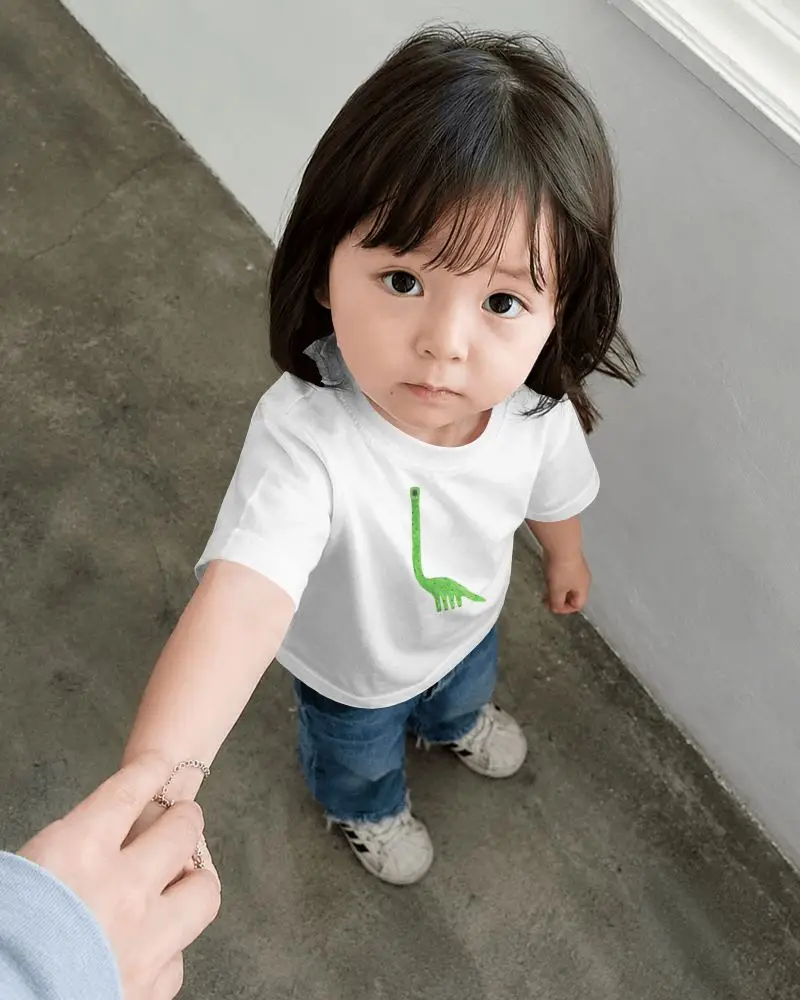 Baby Tee Mockup High Angle Toddler Girl Holding Hand On Concrete Floor Near White Wall