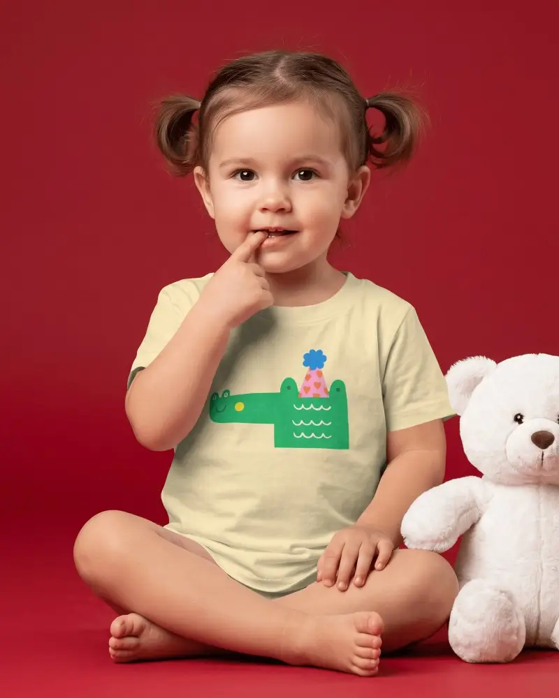 Baby Tee Mockup Toddler Girl Sitting Cross Legged With White Teddy Bear On Red Studio