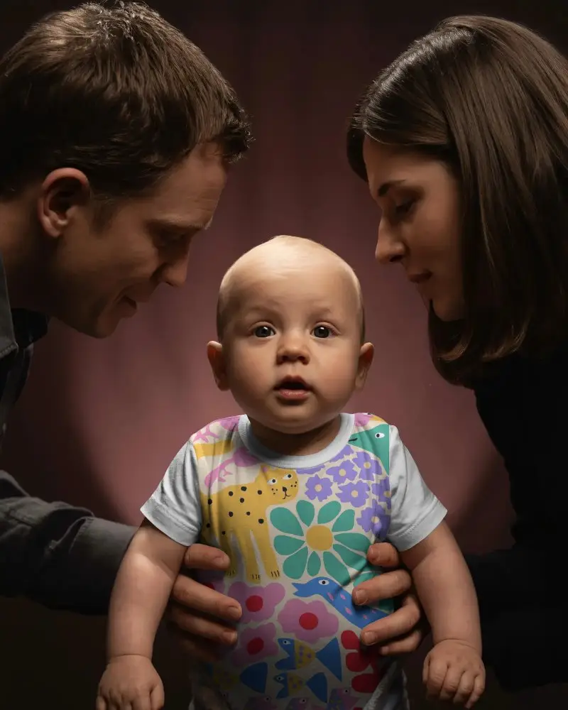 Closeup Baby Tee Mockup With Infant Wearing Cotton Shirt Parents Supporting Tender Moment