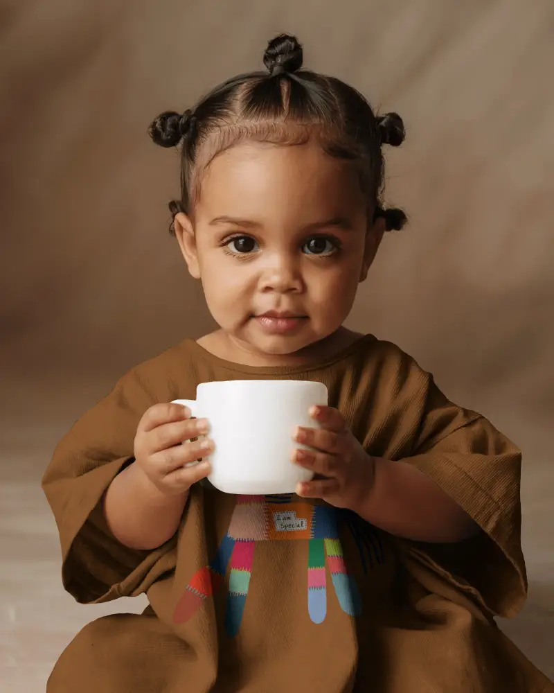 Toddler Holding Cup Baby Tee Mockup Closeup Portrait Natural Expression Soft Studio Light