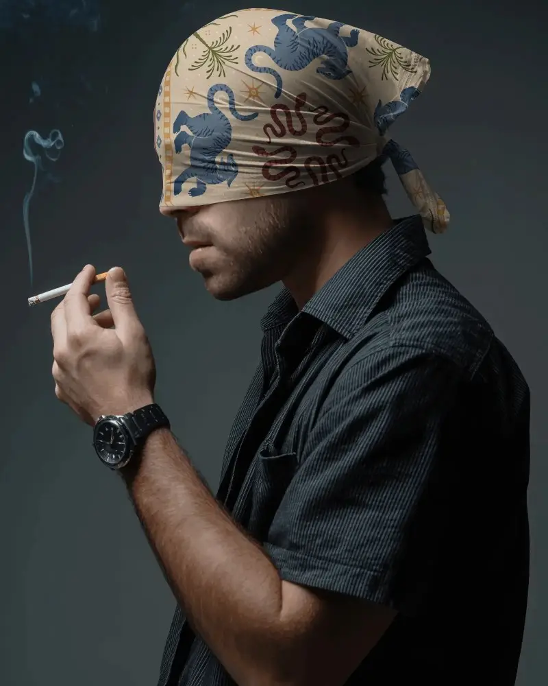 Man With Blindfolded Face Wearing Bandana Mockup Holding Cigarette In Dark Studio Setting