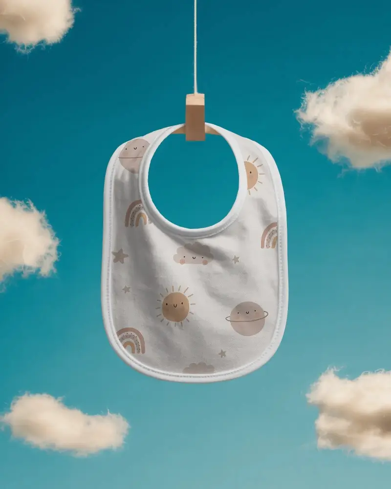 Soft Baby Bib Mockup Hanging On Wooden Clip With Cloud Background For Children