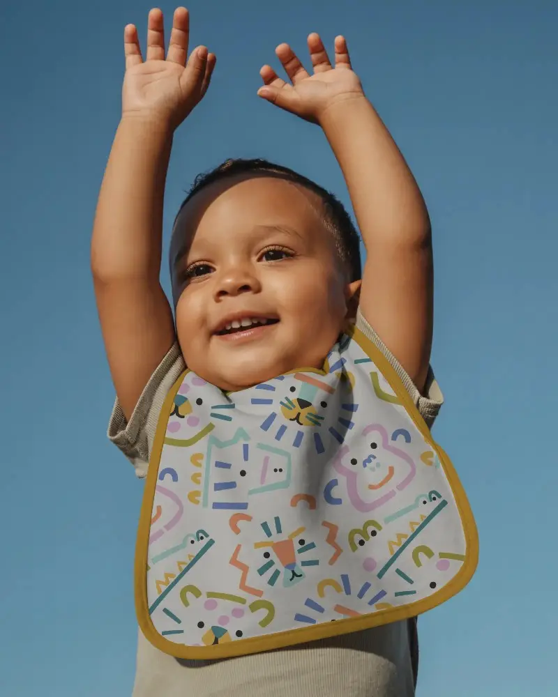 Adorable Child Model With Soft Absorbent Bib Mockup For Stylish And Practical Baby Gear