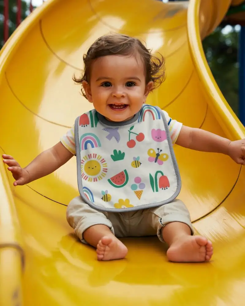 Happy Baby Enjoying Slide Wearing Comfortable Bib Mockup Perfect For Infant Outdoor Activities Pic