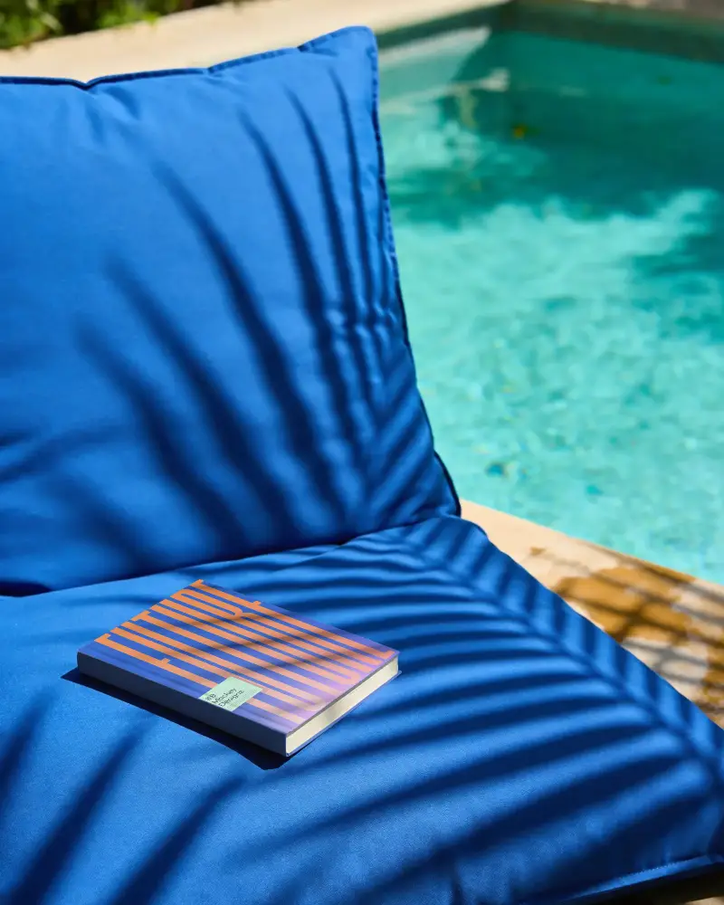 Book Mockup On Luxury Outdoor Lounge By Poolside With Palm Shadow Patterns