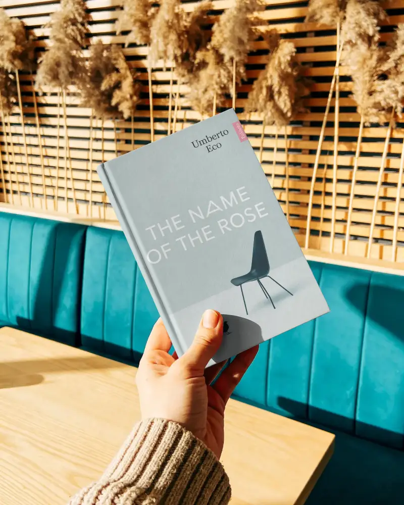 Hand Holding Hardcover Book Mockup With Modern Cozy Background Interior Setting Ideal For Design