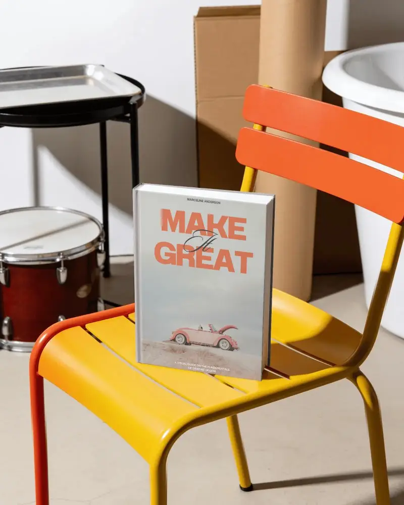 Hardcover Book Mockup On Vibrant Metal Chair For Creative Print Design Projects