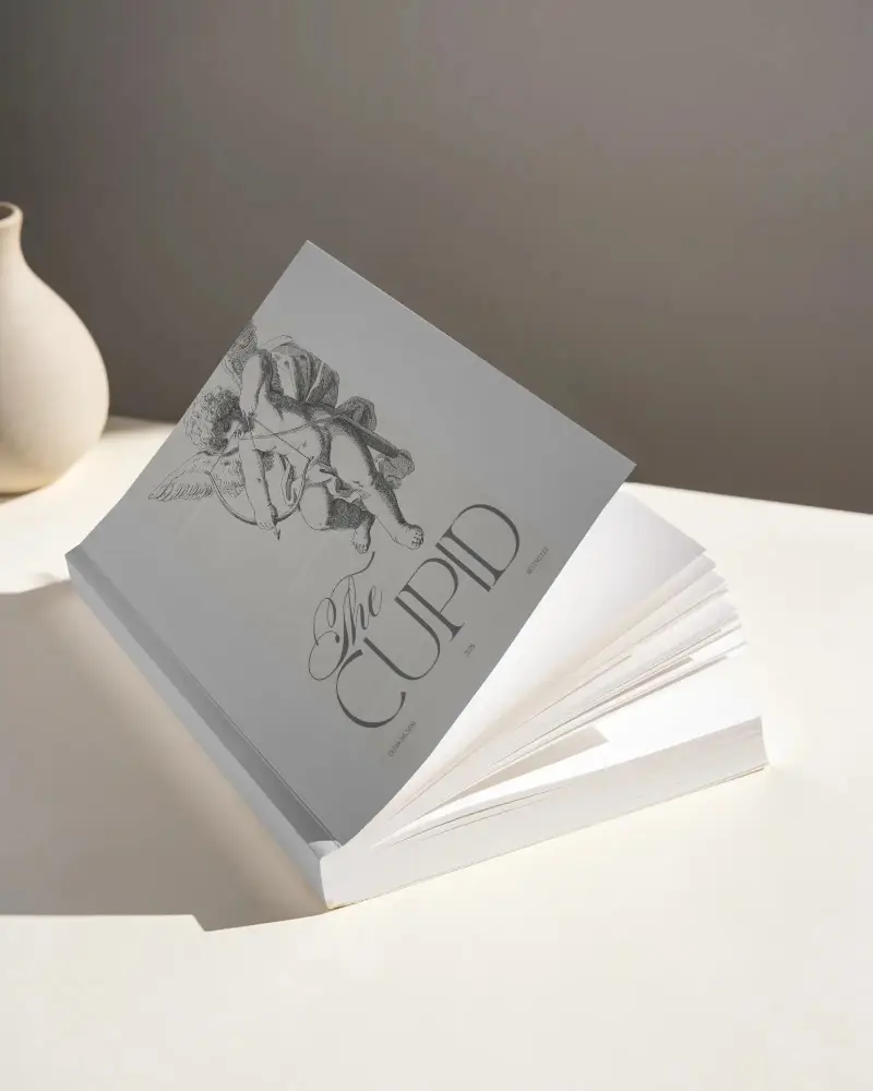 Minimalist Book Mockup With Opened Softcover And Curved Pages Showcasing Plain Cover