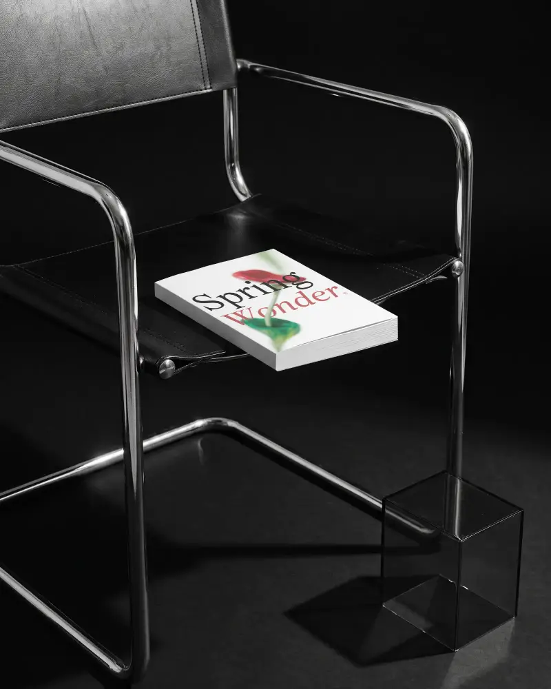 Minimalistic Book Mockup On Modern Chair Isolated On Dark Studio Background For Design