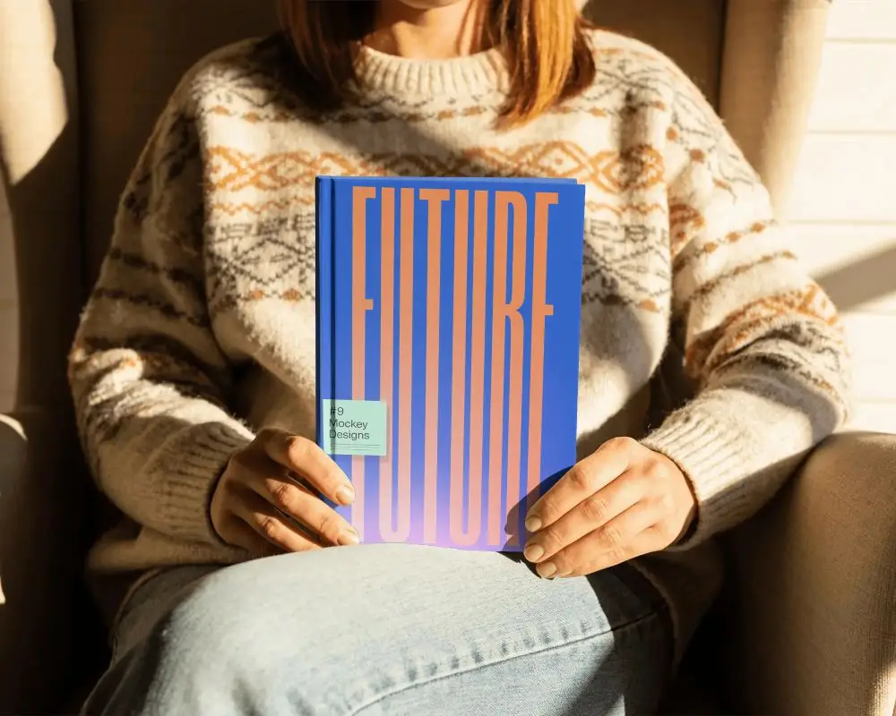 Person Holding Blank Hardcover Book In Cozy Winter Sweater Mockup For Design Display