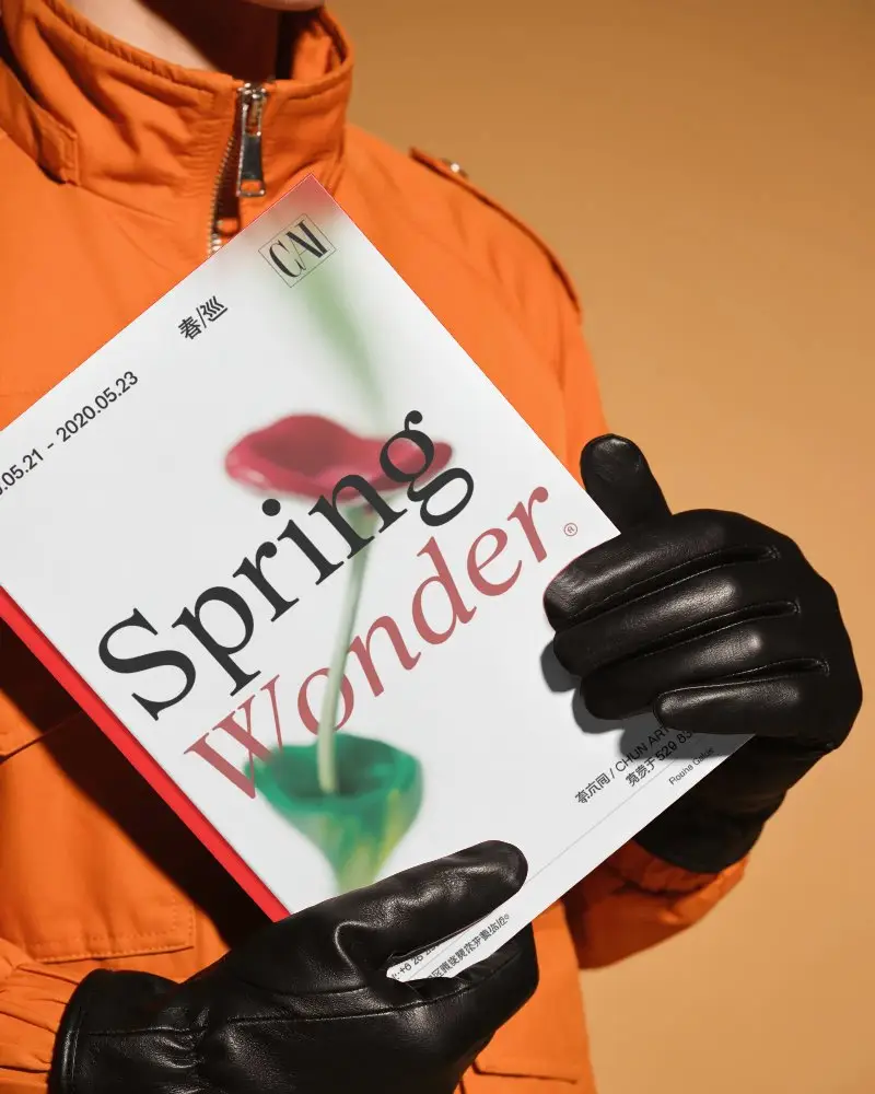 Person Holding Blank Hardcover Book Mockup With Leather Gloves On Orange Background
