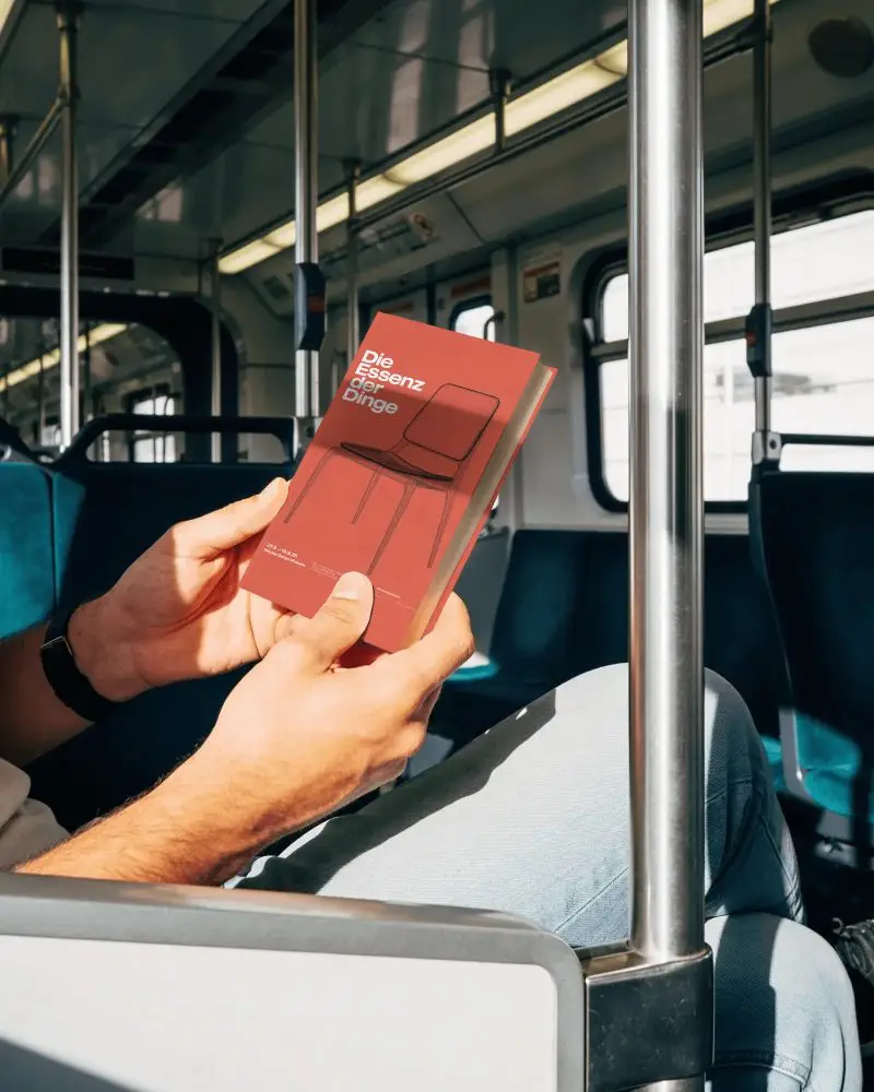 Person Reading Closed Book Mockup Inside Moving Train Urban Travel Theme