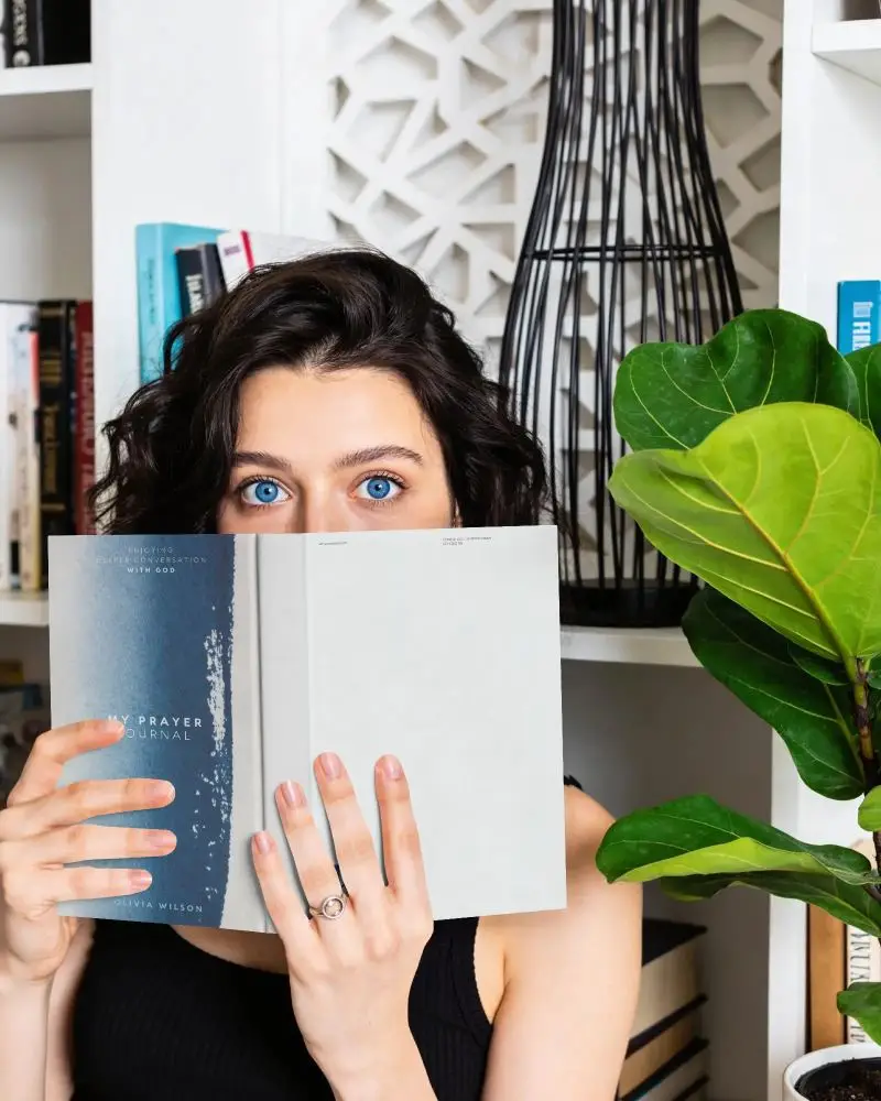 Female Reader With Open Book Mockup In Minimalist Home Library Setting