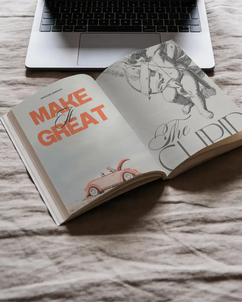 Blank Softcover Book Mockup On Textured Fabric With Laptop In Background For Designs