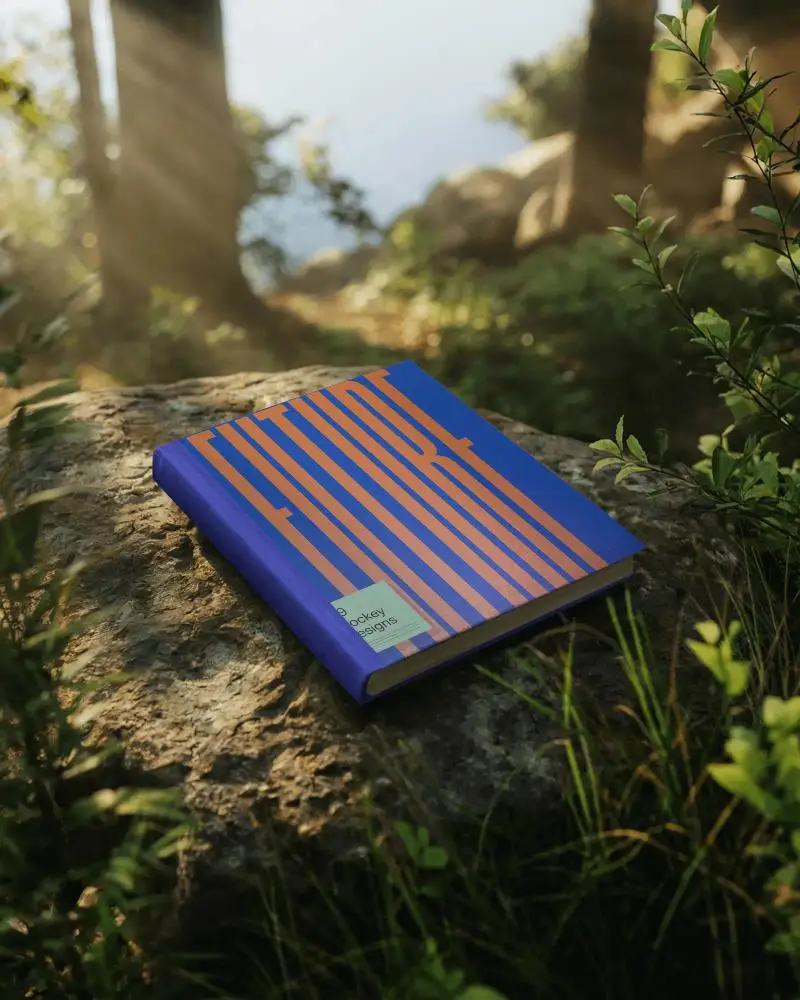 Outdoor Book Mockup Showing Hardcover Lying On Rock In Forest Environment