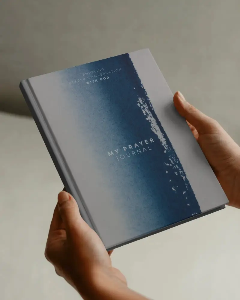 Clean Studio Book Mockup In Hand Close Up With Soft Lighting And Neutral Background Focus