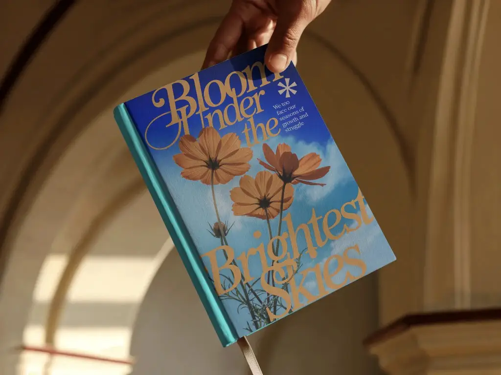 Person Holding Open Book Mockup By Corner Inside Arched Building Soft Sunlight On Minimal Backdrop