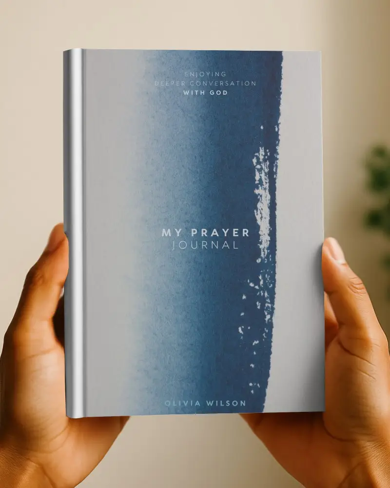 Vertical Book Mockup Held By Hands Soft Warm Lighting Neutral Background With Plant Blur