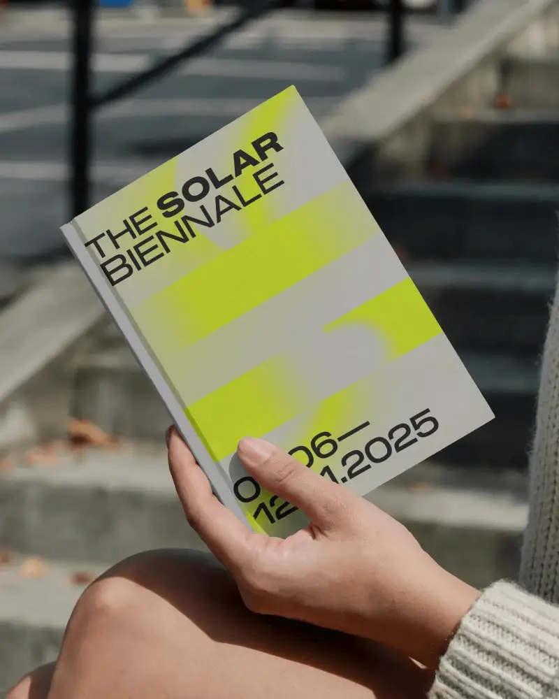 Outdoor Hand Holding Book Mockup On Steps In Soft Sunlight With Autumn Leaves