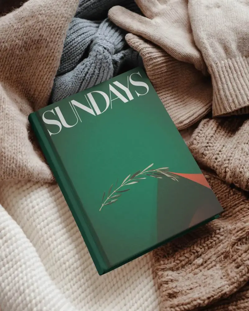 Ozy Winter Book Mockup Nestled In Knit Scarves And Gloves Soft Textile Surroundings