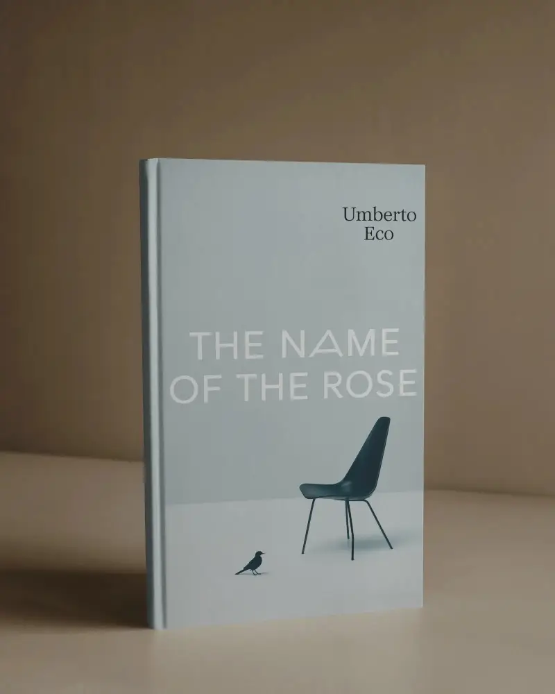 Standing Book Mockup Against Warm Beige Wall On Minimal Desk In Studio Lighting