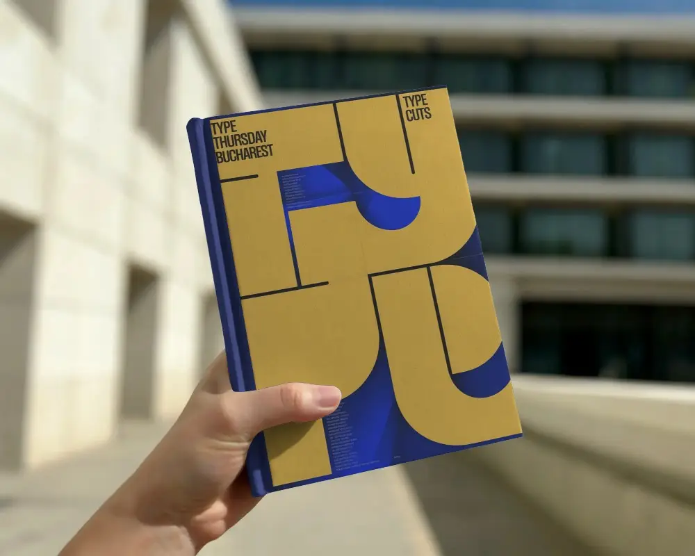 Hand Holding Book Mockup Outdoors With Modern Building In Sunny Daylight Background