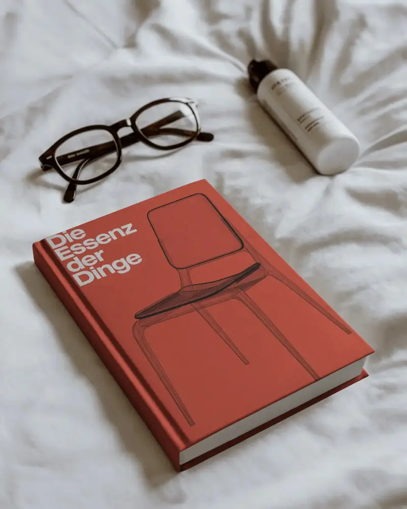 Clean Minimalist Book Mockup With Sunglasses And Cosmetic Bottle On White Fabric