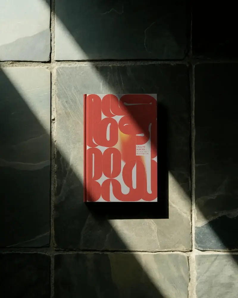 Hardcover Book Mockup On Textured Stone Tiles With Natural Sunlight Shadow Effect