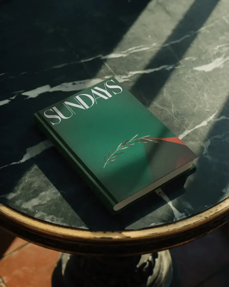 hardcover-book-mockup-placed-on-marble-table-with-natural-light-and-shadow-effects