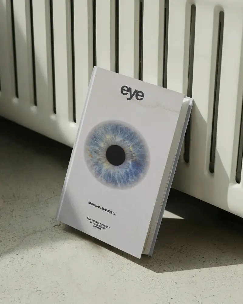 Hardcover Book Mockup Standing Against Radiator In Natural Light On Textured Floor