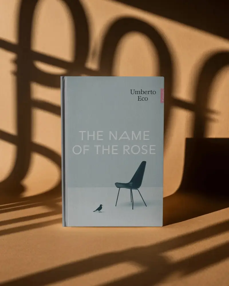 Hardcover Book Mockup On Textured Surface With Dramatic Shadow Play For Design