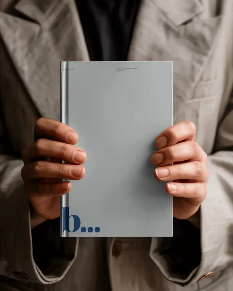 Person Holding Minimalist Hardcover Book Mockup For Modern Book Design Presentation