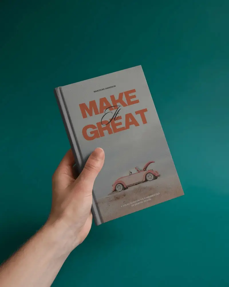 Hand Holding Hardcover Book Mockup Against Deep Teal Studio Background