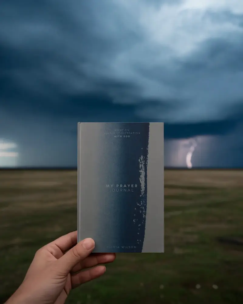 Hardcover Book Mockup Blank Cover In Hand With Dark Clouds And Lightning Storm