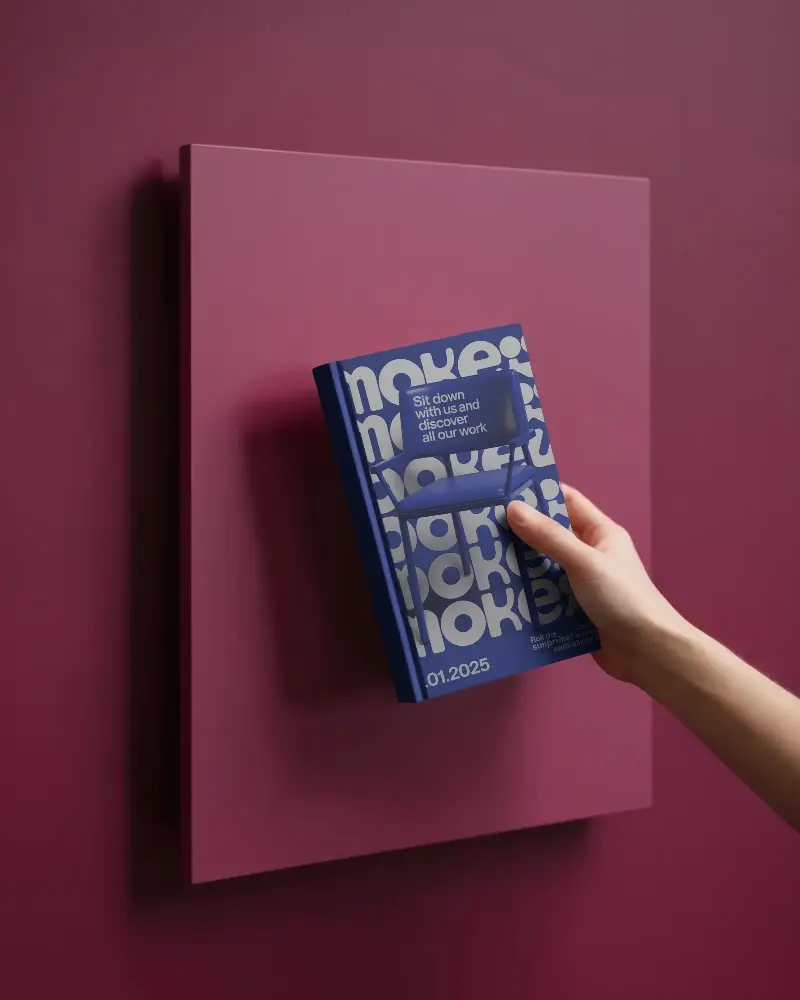 Vertical Book Mockup With Plain Cover Held By Human Hand On Monochrome Panel